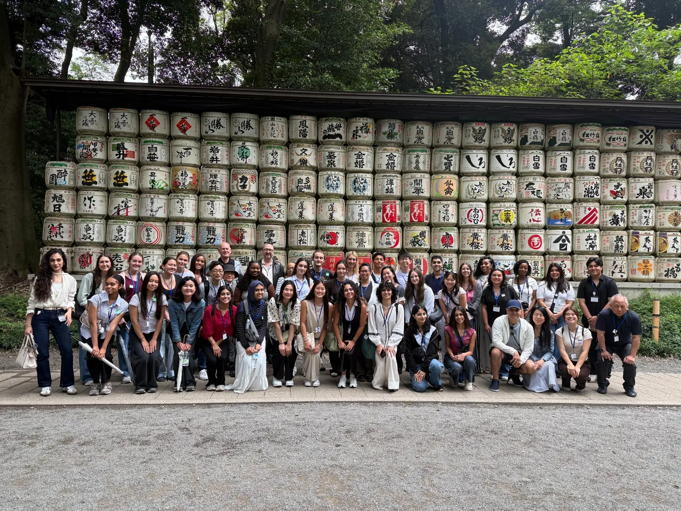 Japan International Health Scholar Intensive cohort in front of traditional Japanese sake barrels