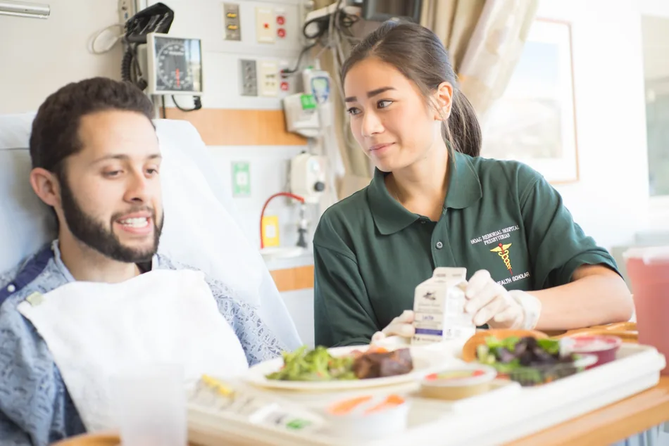 COPE Health Scholar supporting a patient during a clinical care experience
