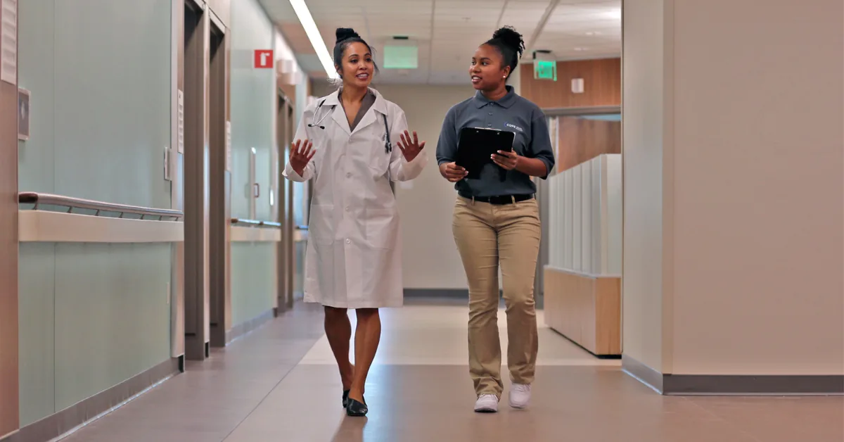 Care Navigator Scholar in a clinical setting with a healthcare professional