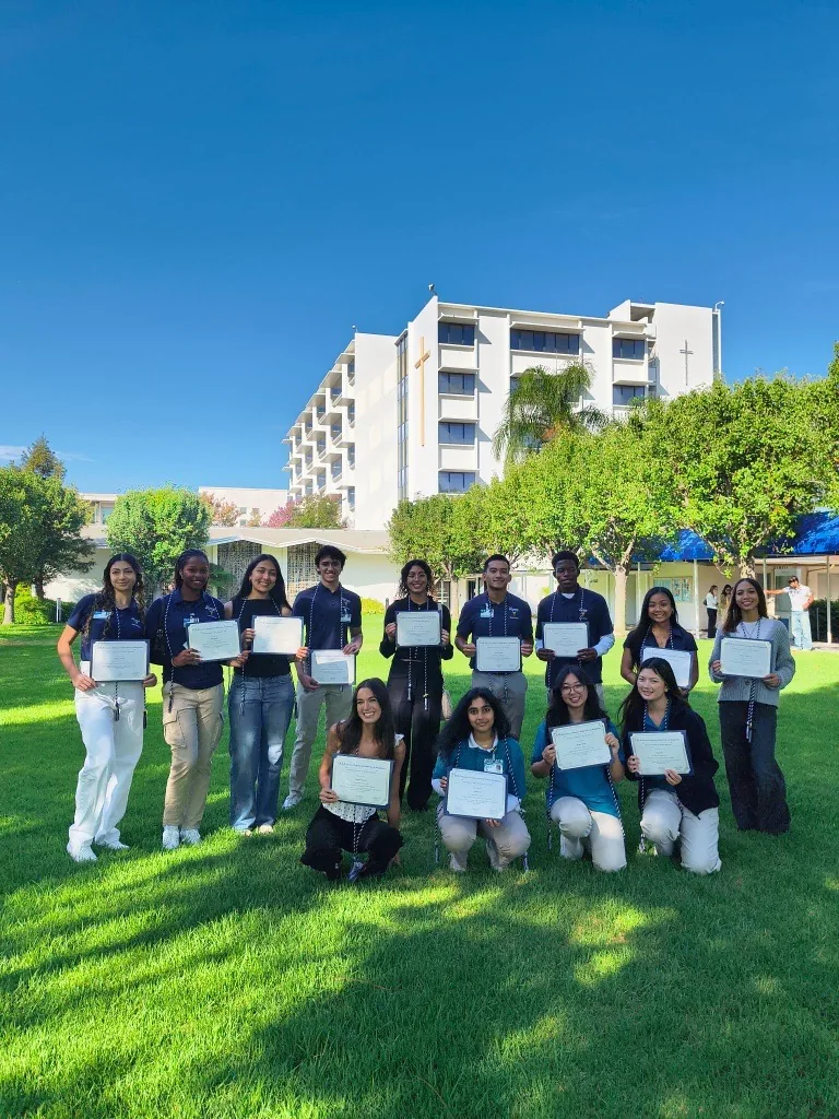 COPE Health Scholars cohort celebrating with completion certificates outdoors