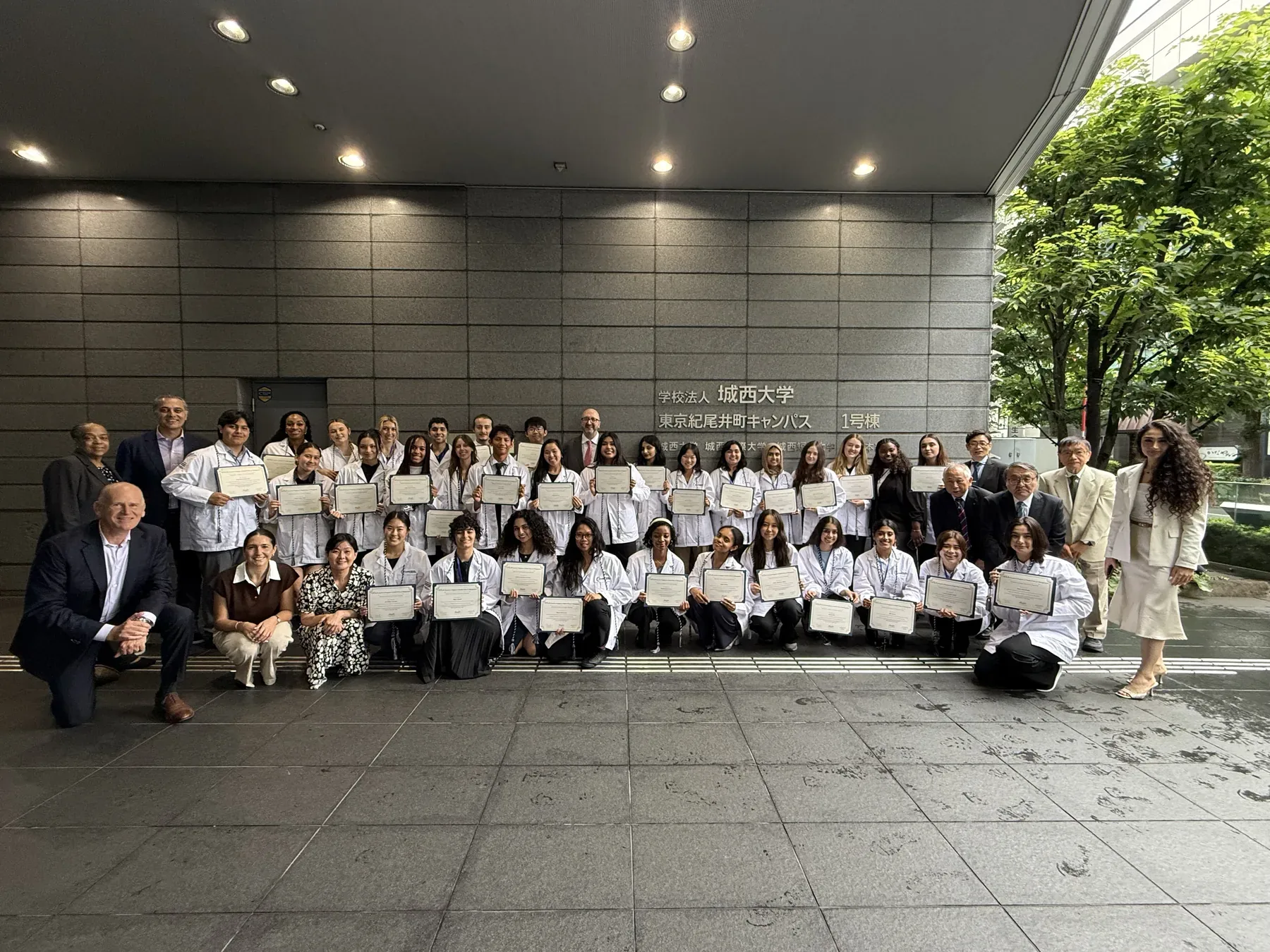COPE Health Scholars participants in Japan gathered outside with certificates